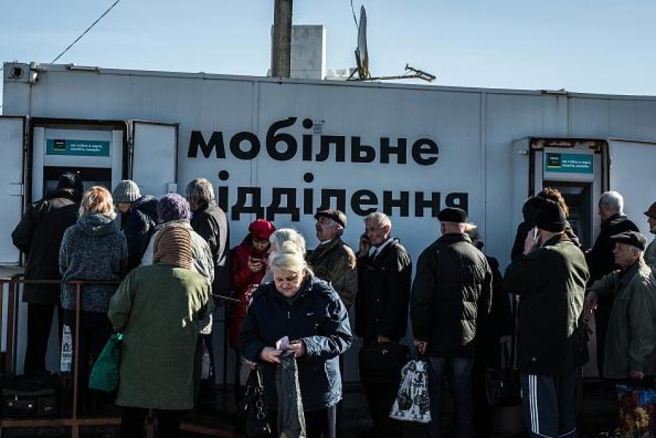 Older people lining up at bank machines in government-controlled areas of Ukraine.