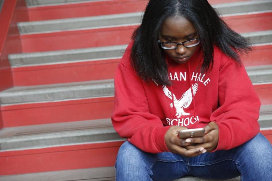 A student checks her phone at Nathan Hale Elementary School in Chicago