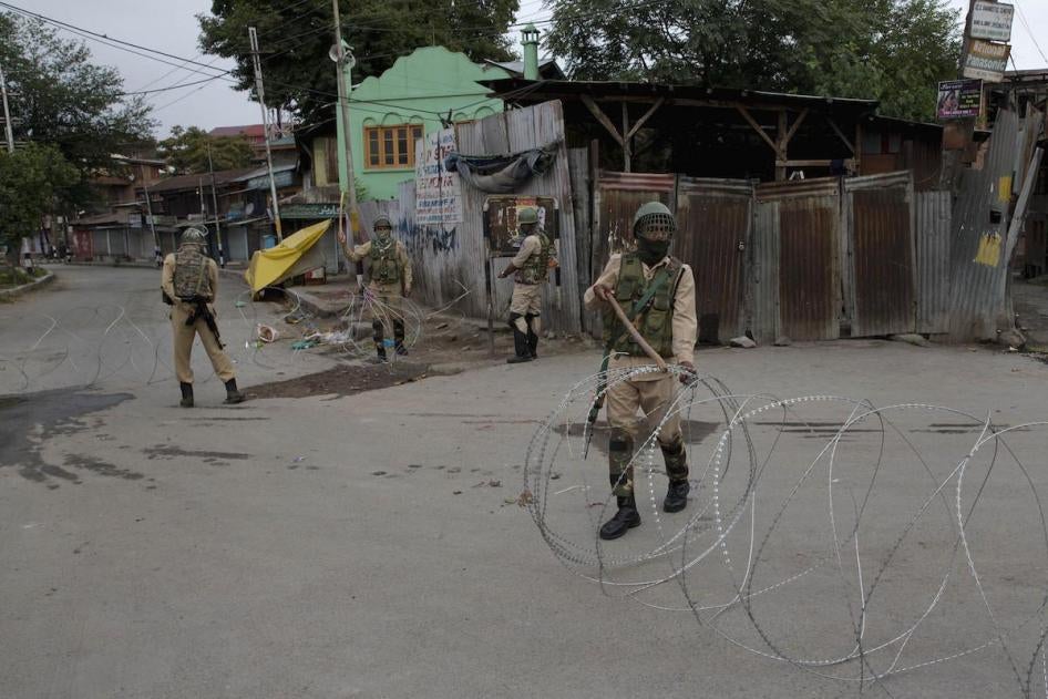 Indian paramilitary soldiers prepares to block a road with barbed wires during security lockdown in Srinagar, Indian controlled Kashmir, Sunday, Aug. 18, 2019. (AP Photo/ Dar Yasin)