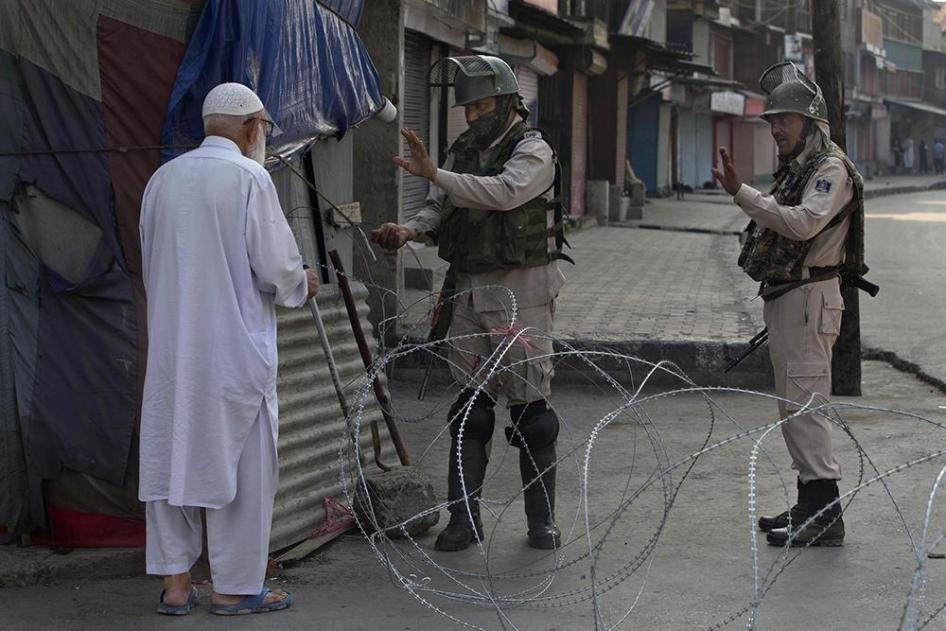 喀什米尔居民在斯里那加市通过临时检查站时，被执行封锁任务的印度民兵拦查身份，2019年8月23日星期五。