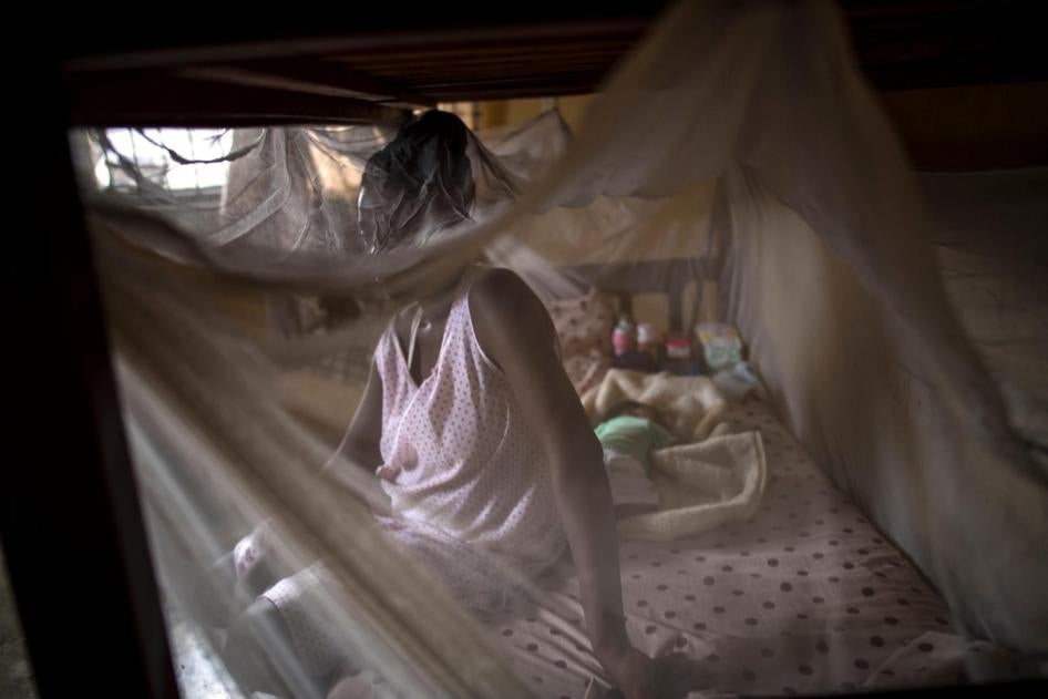 A woman from Cameroon sits with her baby in a private shelter in Lagos, Nigeria.