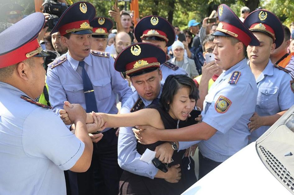 Kazakhstan police officers detain a protester during an opposition rally in Almaty, Kazakhstan.
