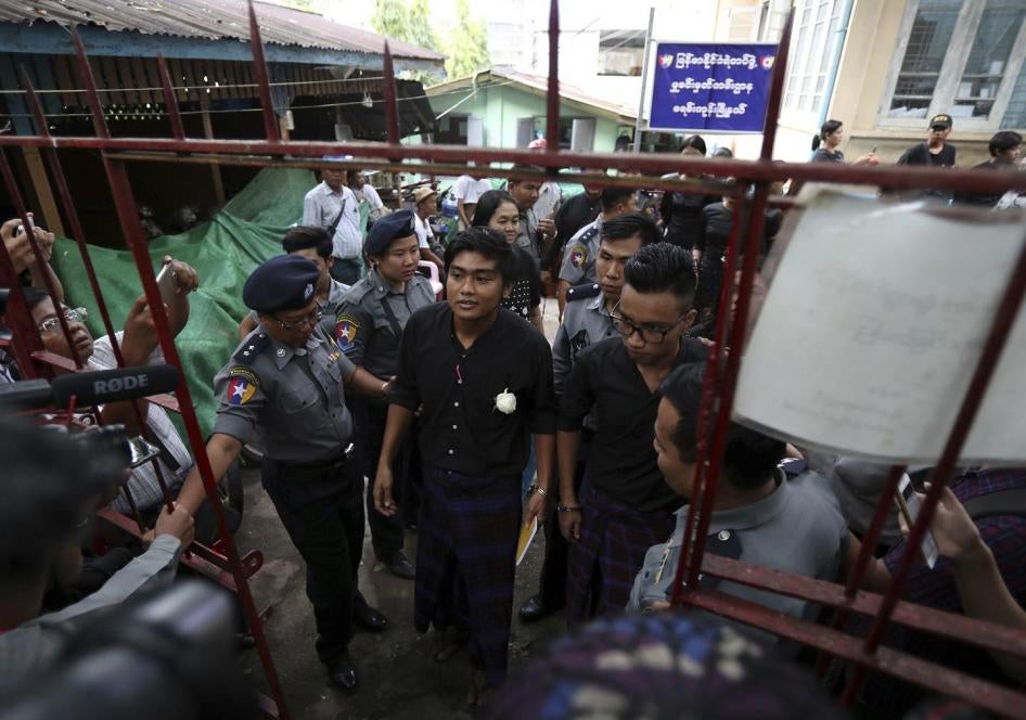 Zayar Lwin, center left, member of Student Union and a leader of Peacock Generation "Thangyat" Performance Group, talks as he leaves a township court along with his colleague Paing Phyo Min, right, after their trial Wednesday, Oct. 30, 2019, in Yangon, My