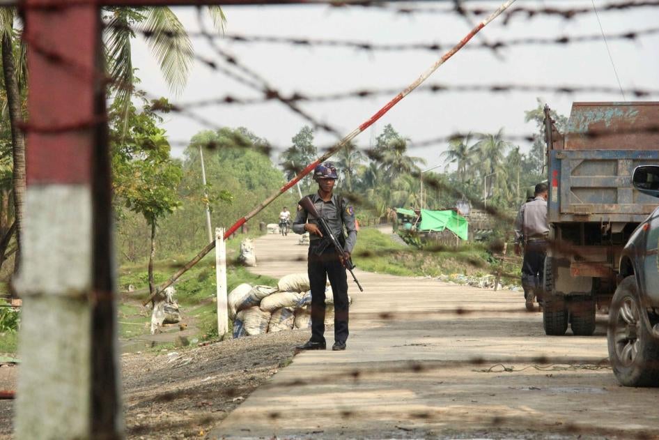 A police officer stands guard at a checkpoint in Shwe Zar village, northern Rakhine state, Myanmar, September 6, 2017.