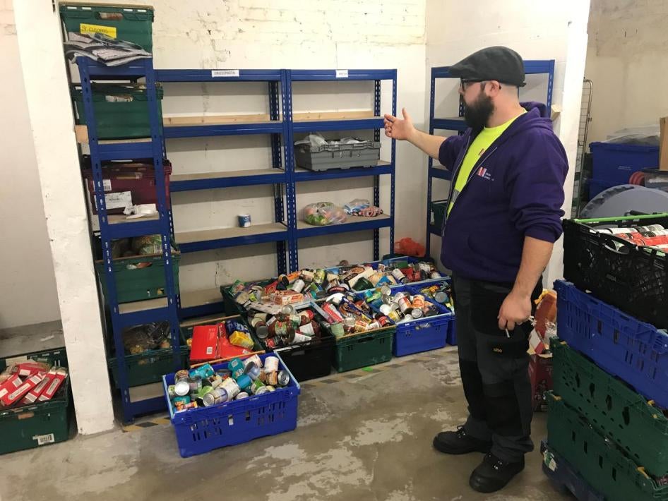 Martin Fuller, who is responsible for MICAH Liverpool’s storeroom, explains current low stock levels in the organization’s warehouse between a delivery to a food bank distribution and a collection of donations at another church. October 8, 2019. 