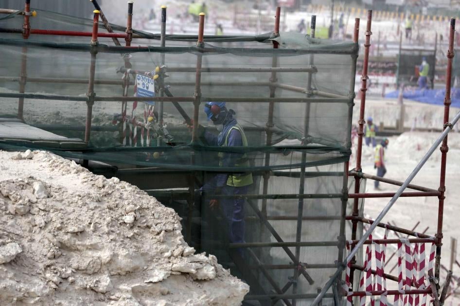 عامل أجنبي يتسلق سقالة في ملعب الوكرة وهو قيد الإنشاء من أجل كأس العام 2022، في الدوحة، قطر. 