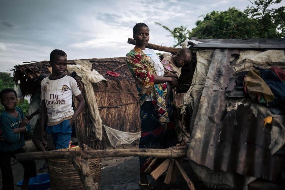 Abyssine Miniunga, internally displaced on an islet in the middle of the Congo River near Yumbi, poses near her shelter for a photograph on January 28, 2019.
