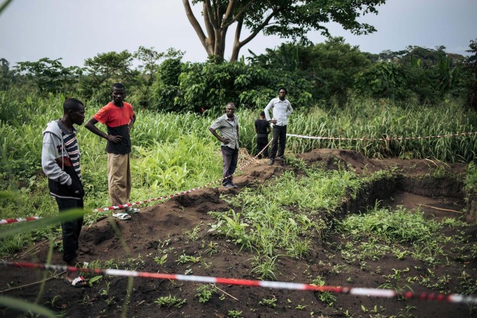 Des survivants de l’attaque à Bongende, dans le territoire de Yumbi, en République démocratique du Congo, sur le site d’une fosse commune où une centaine de corps auraient été enterrés, le 27 janvier 2019.