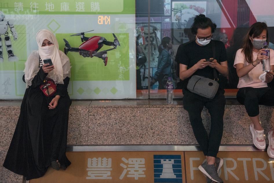 Residents use their phones during a protest in Hong Kong, November 11, 2019.