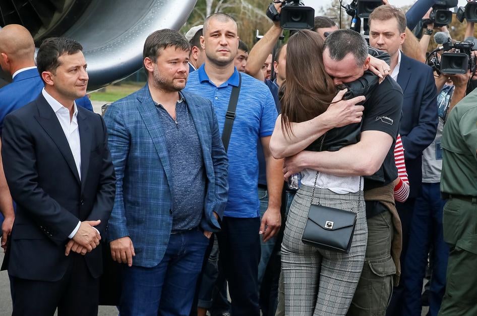 Ukrainian film director Oleg Sentsov, jailed on groundless terrorism charges in Russia, hugs his daughter at a welcoming ceremony at Borispil International Airport outside Kiev.