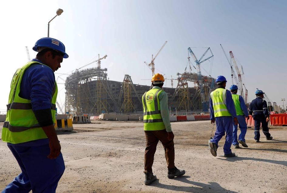 Workers walk towards the construction site of the Lusail stadium which will be build for the upcoming 2022 Fifa soccer World Cup during a stadium tour in Doha, Qatar, December 20, 2019. 