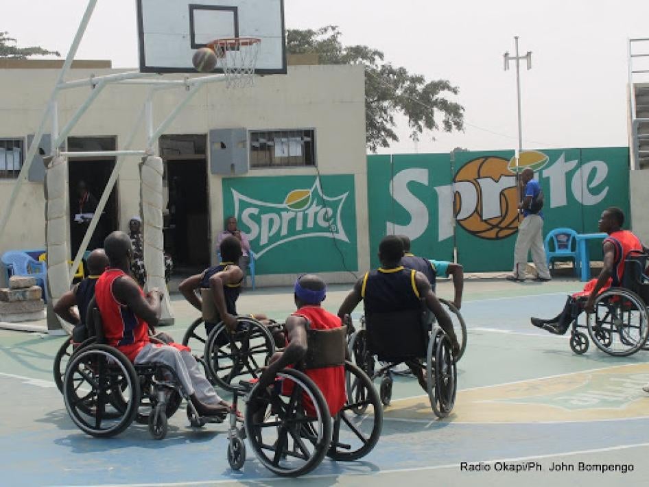Men in wheelchairs play a game of basketball outside in the Democratic Republic of Congo. 