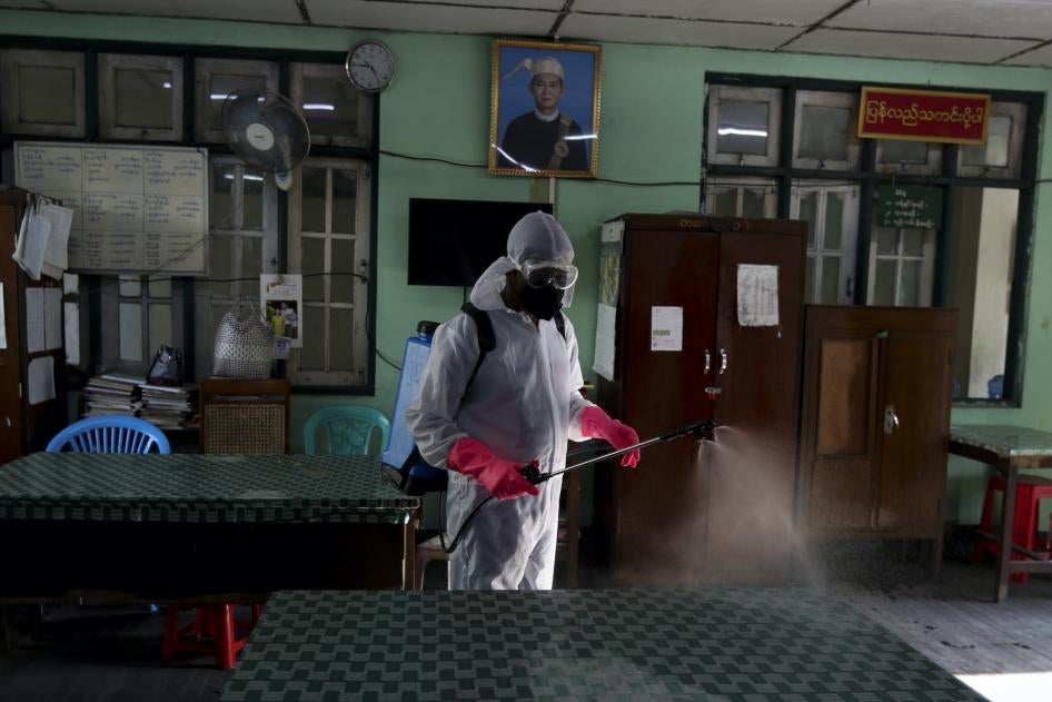 A city worker disinfects government offices as a preventive measure against the coronavirus, Yangon, Myanmar, March 25, 2020.
