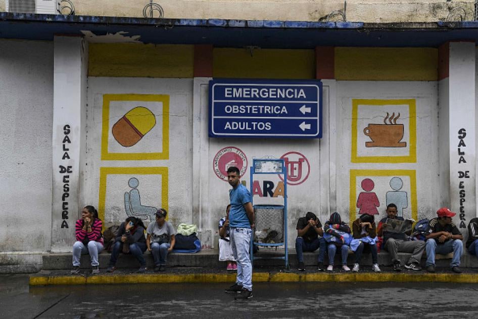 Relatives of patients that are treated at the University Hospital wait in front of the building in Barquisimeto, Venezuela on April 24, 2019.