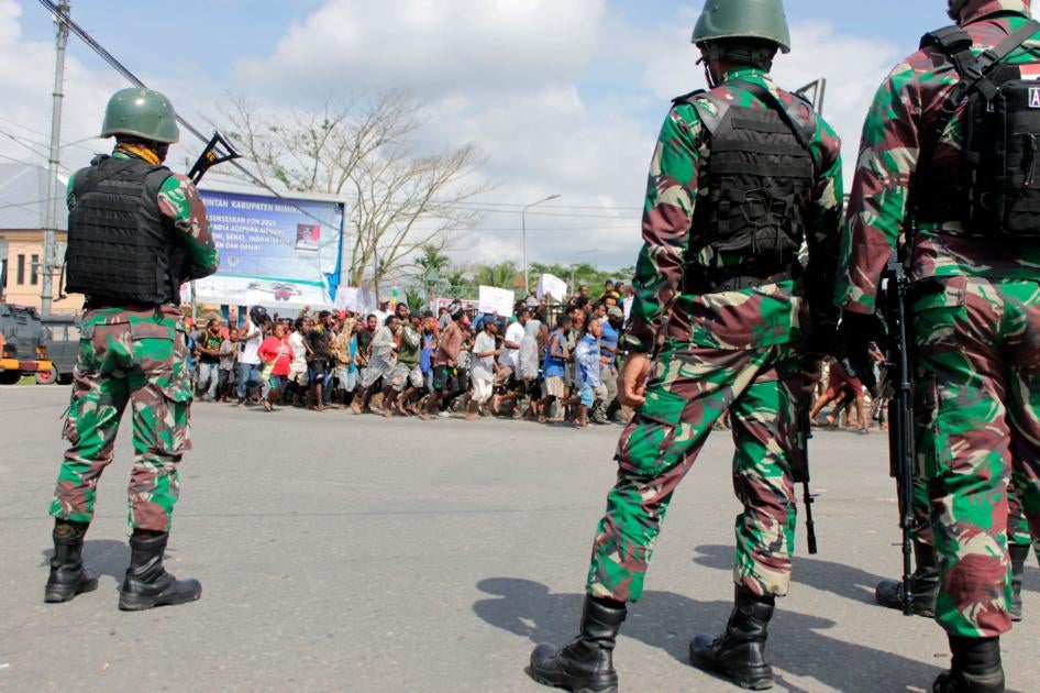 Indonesian soldiers stand guard during a protest in Timika, Papua province, August 21, 2019.