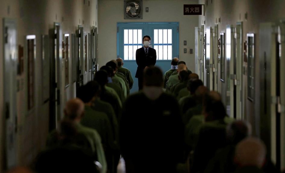 A prison officer stands in front of older inmates who attend slow-paced exercises in a special building set aside for prisoners unable to do regular prison factory work, at the prison in Tokushima, Japan, March 2018. 