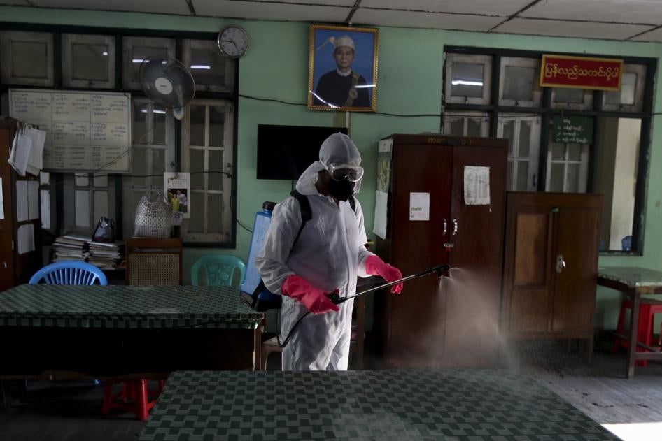 A member of the Yangon City and Development Committee disinfects government offices to help curb the spread of the new coronavirus in Yangon, Myanmar Wednesday, March 25, 2020. 