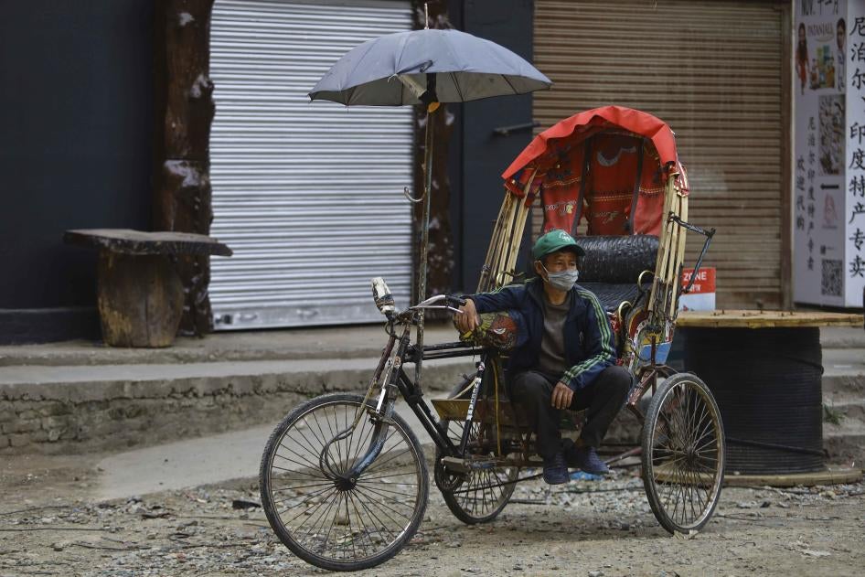 Rickshaw driver with mask on in Nepal 