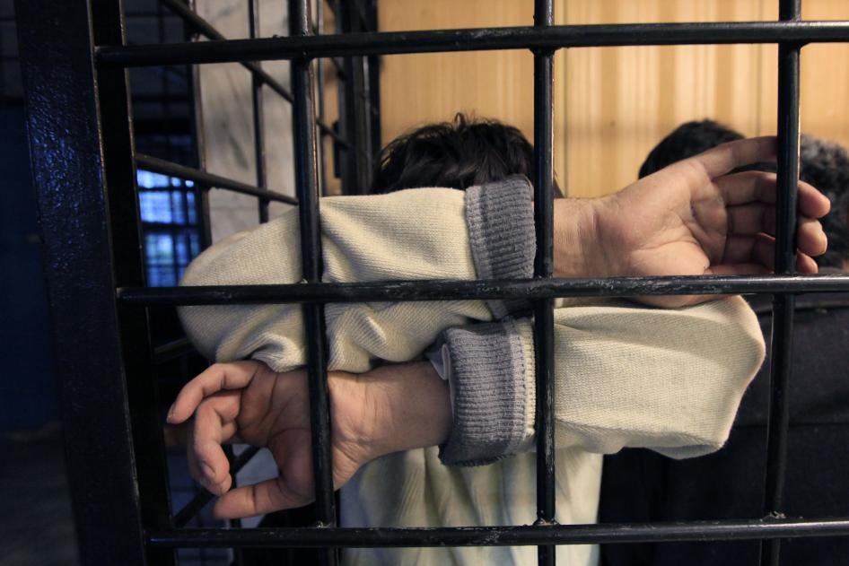 A detained migrant from a former Soviet republic waits in a holding cell at a police station in Russia's Siberian city of Krasnoyarsk. 