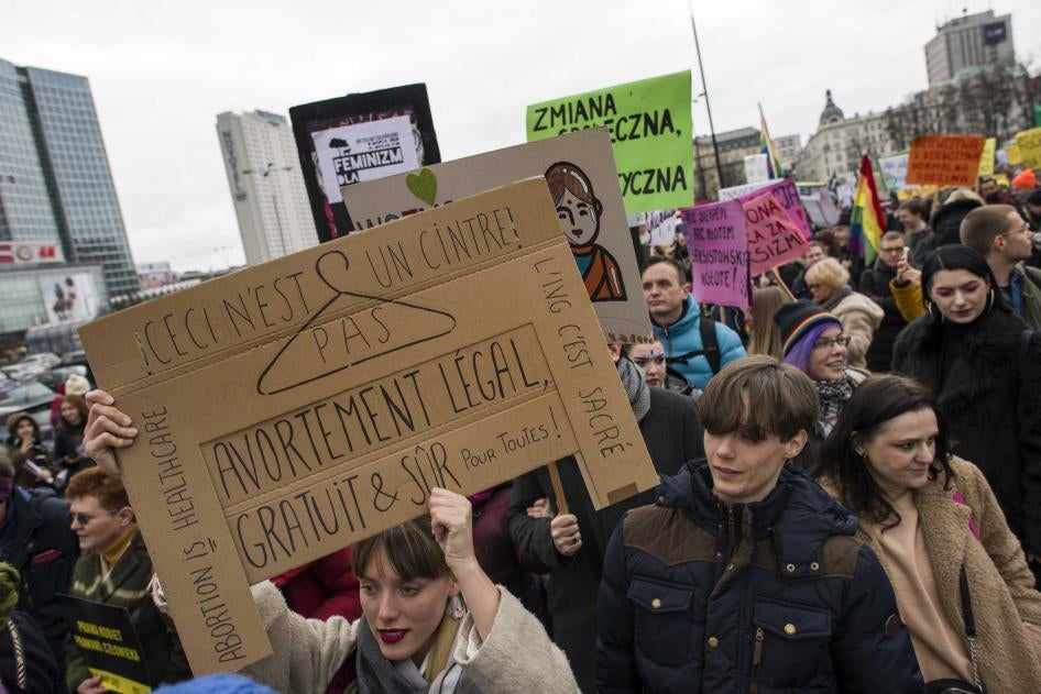 Une jeune femme brandit une pancarte dont le texte est inscrit en français, lors d’une manifestation tenue à Varsovie, en Pologne, le 8 mars 2020 (Journée de la femme), deux jours avant l’interdiction par le gouvernement de rassemblements publics afin d’e