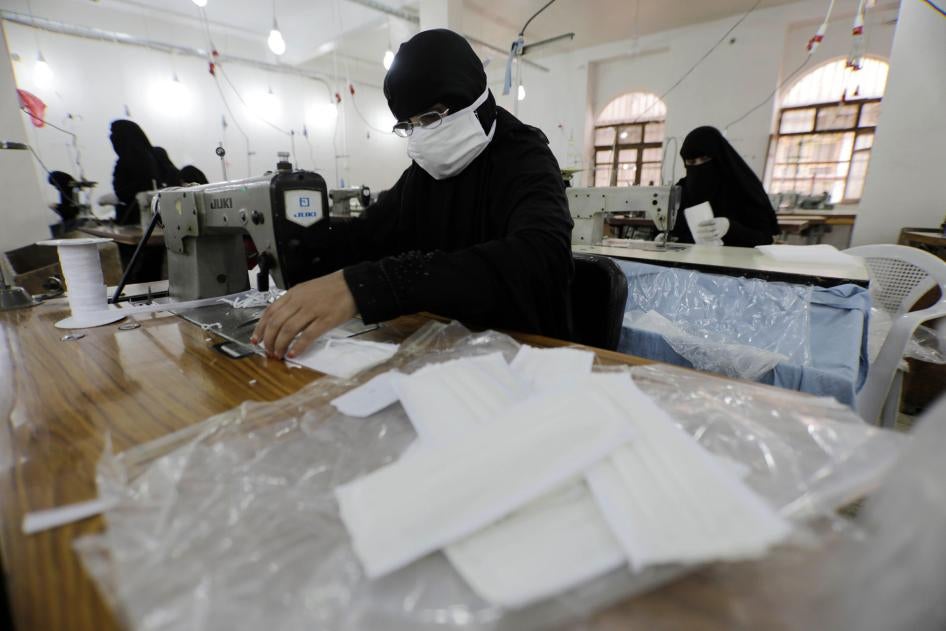 Yemeni women work to manufacture protective face masks at a textile factory in Sanaa, Yemen, March 17, 2020.