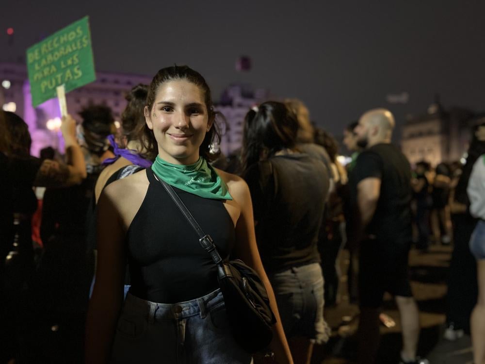 A woman poses for a photo at a rally