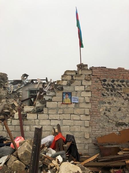 A photograph of Arthur Guliyev, 13, hangs on the wall of his former home in Ganja. He died from his wounds a week after a ballistic missile hit the neighborhood on October 17.