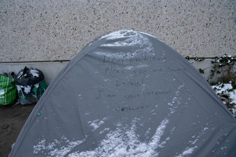 A gray tent with writing on it