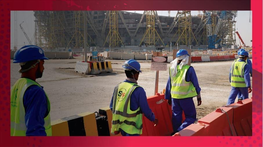 Workers walk toward the construction site of Lusail stadium, which is being built for the 2022 men's soccer World Cup, during a stadium tour in Doha, Qatar, on Dec. 20, 201 