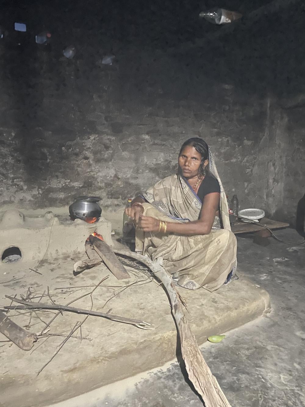 Wife of a deceased migrant worker in the family kitchen in Nepal.
