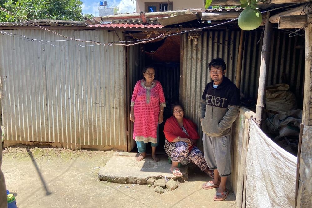 A family stands in front of their home