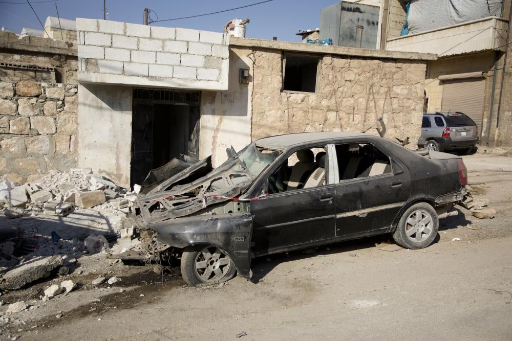 A destroyed car stands amid the rubble caused by Syrian government forces' bombing of the town of Termanin in the northern countryside of Idlib, October 14, 2023. 