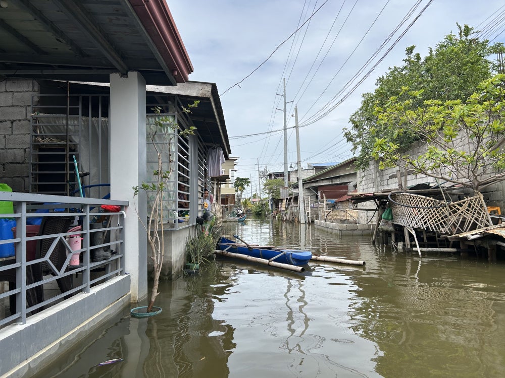 One of the community boats used to ferry people during the day's most flooded time at the Pulo relocation site, July 12, 2026.