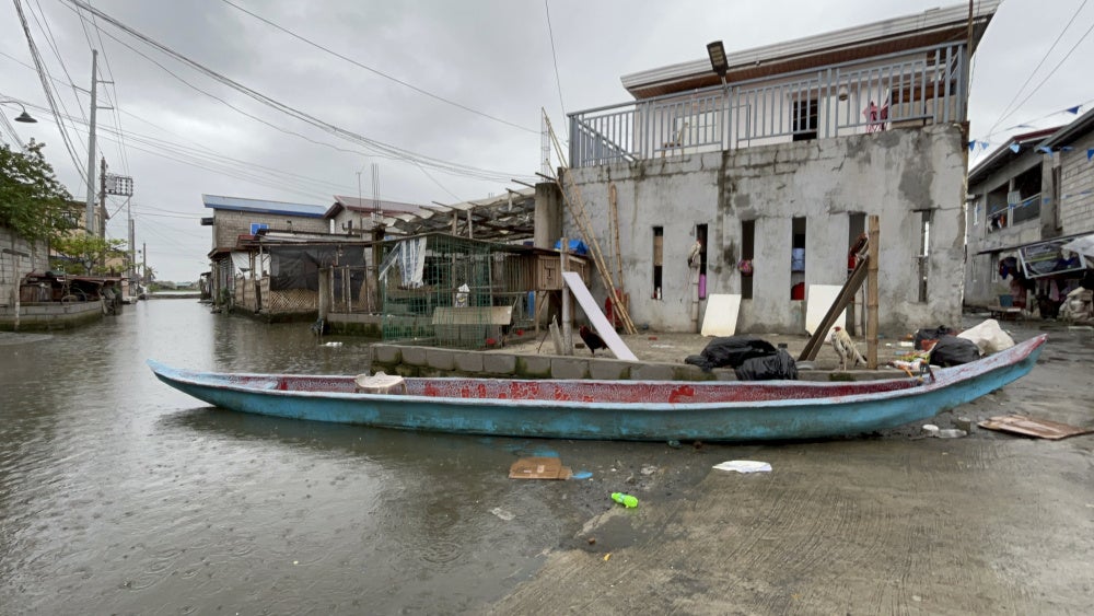 The community boat that ferries people across the flooded Pulo relocation site, July 13, 2026.
