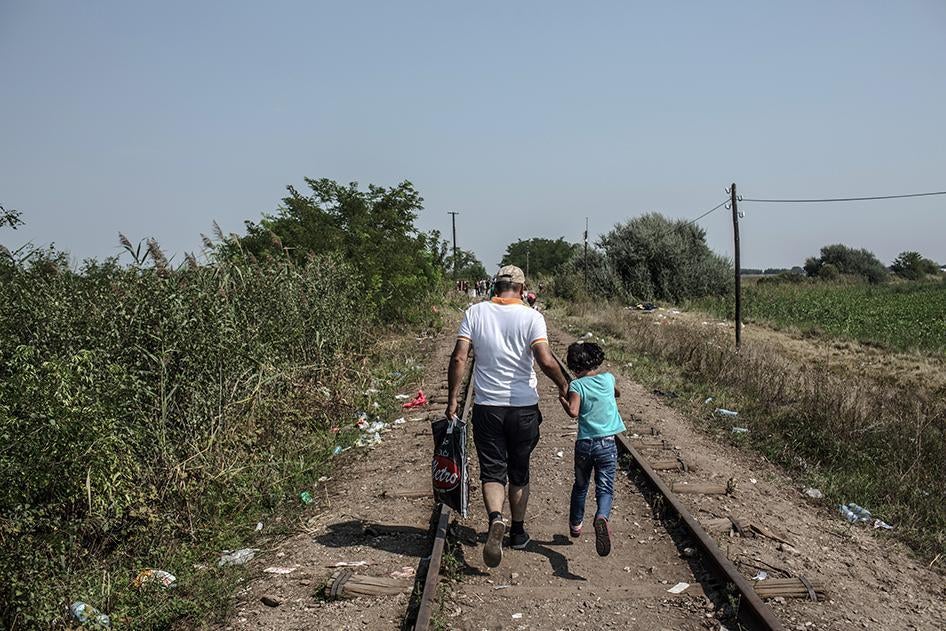 Walking on train tracks in Horgos, Serbia, refugees make their way to the border to cross into Hungary. September 1, 2015.