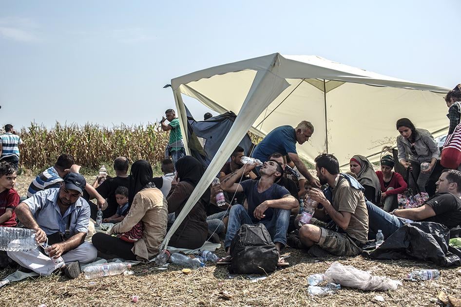 Refugees and asylum seekers rest near Röszke, Hungary after crossing the Serbian-Hungarian border. September 1, 2015.