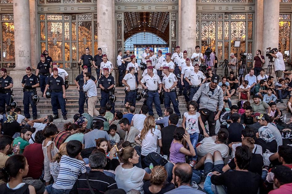 Hungarian police stand in front of the entrance to the Keleti train station in Budapest, Hungary barring entry to the many refugees and asylum seekers who wait to board trains to Germany. September 1, 2015. 
