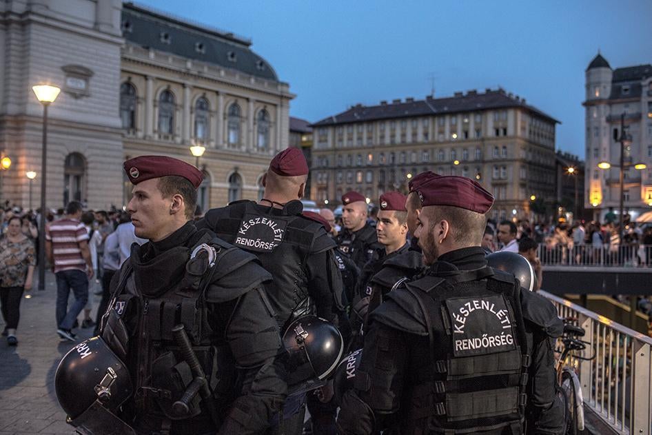 Riot police stand in front of Budapest's Keleti train station in Hungary where hundreds of refugees and asylum seekers wait to be let on trains to Germany. September 2, 2015.