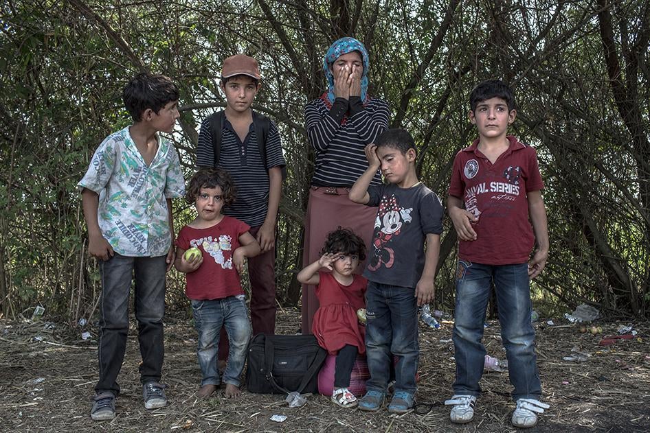 A portrait of Sabah, 35, a Syrian Kurdish refugee from Kobane, with her six children at the Serbian-Hungarian border in Röszke, Hungary, September 3, 2015.
