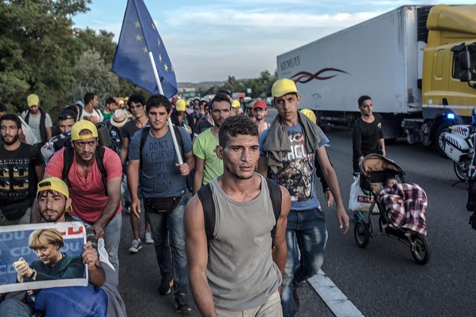 Refugees and asylum seekers walk along the Hungarian M1 highway near Budapest heading toward Vienna, Austria. September 4, 2015.
