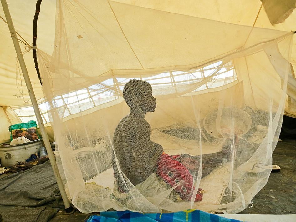 Nyanial, 22, nurses one of her three children in the UNMISS camp near Bentiu in June. Soldiers and militia attacked her town in Koch county in May 2015. 