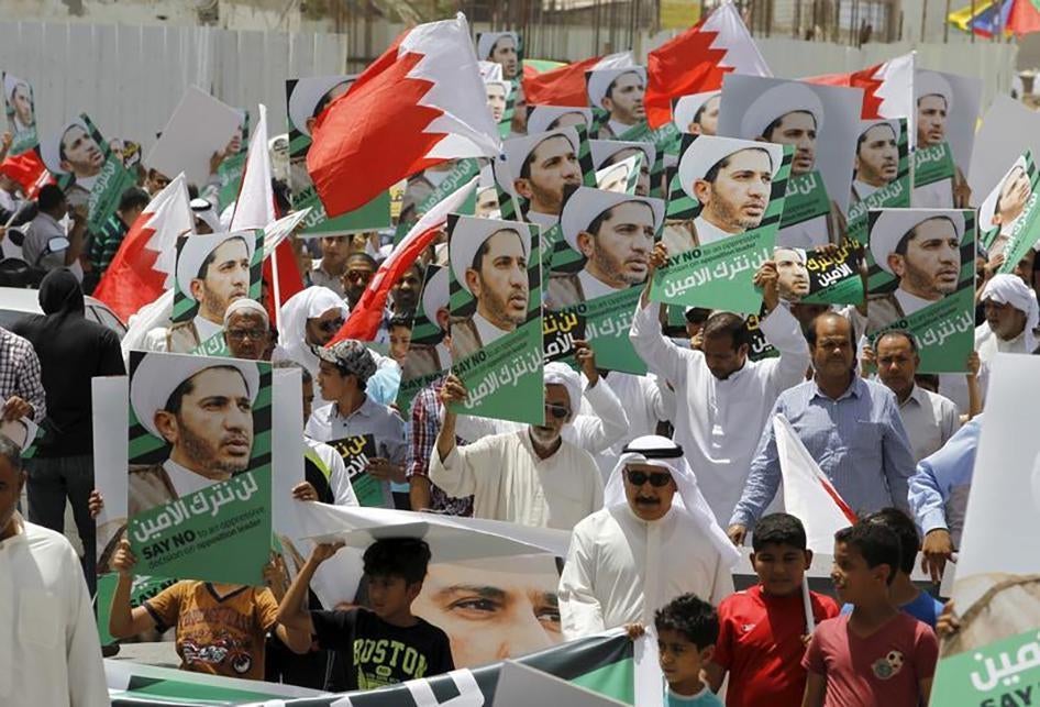 Protesters holding photos of Bahrain's main opposition leader Ali Salman march during an anti-government protest in the village of Diraz, west of Manama, Bahrain on June 12, 2015. 