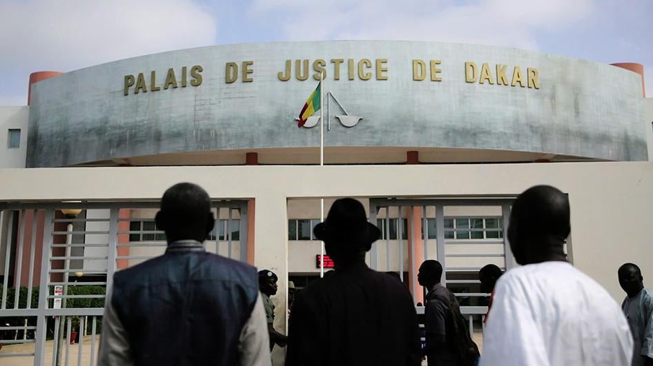 Clement Abaifouta, Souleymane Guengueng and Abdourahmane Guèye, stand outside of the courthouse where the trial of Hissène Habré will be held, on July 13, 2015 in Dakar, Senegal. The trial is set to begin on July 20, 2015. © 2015 Human Rights Watch