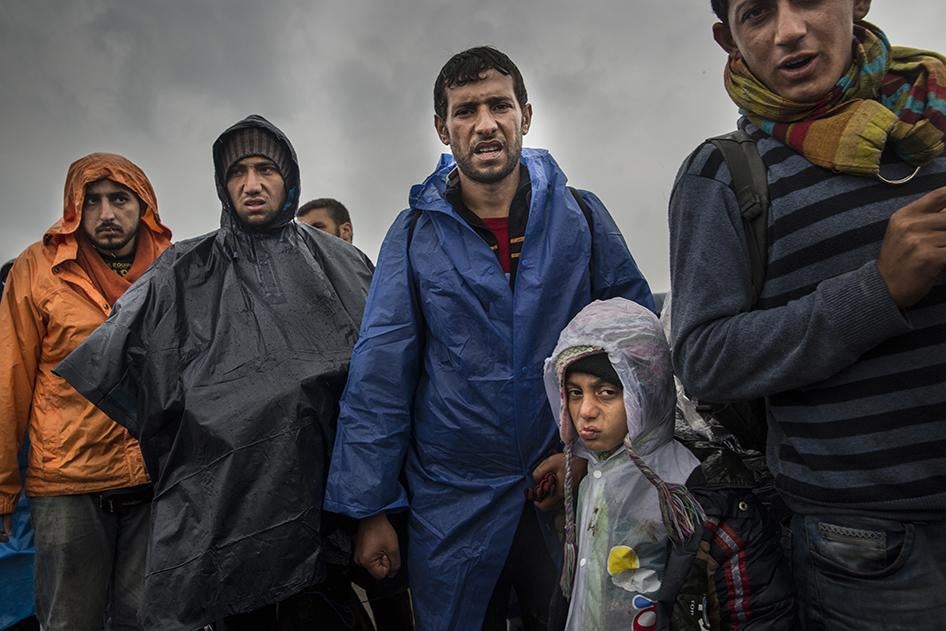 A group of Afghans and Syrians among several thousand waiting to board buses at a collection point in Roszke, Hungary where they will be taken to detention centers for processing.  September 10, 2015. 