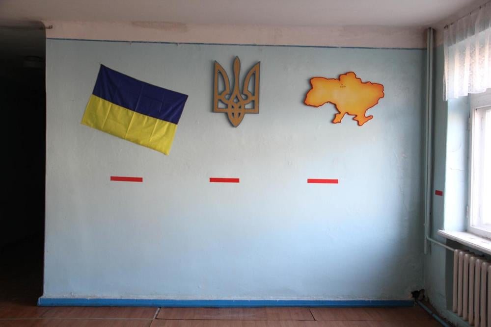Red tape on the hallway walls of School Number 1 in Marinka marks the line below which students should shelter in case of attack in order to avoid injury from shattering windows. © 2015 Bede Sheppard/Human Rights Watch