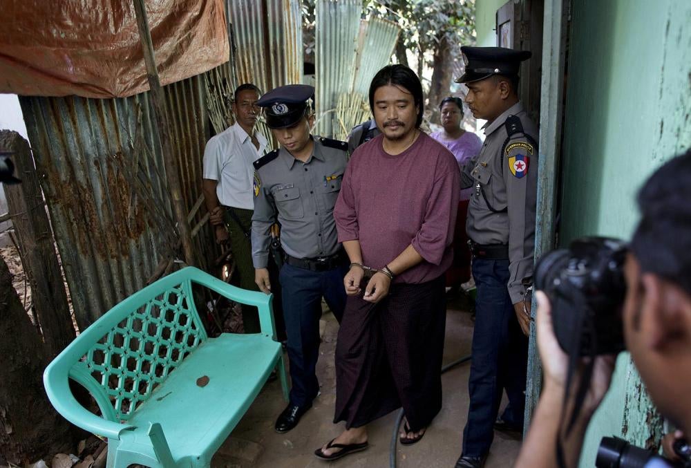 Police officers escort humanitarian worker Patrick Khum Jaa Lee during a court hearing in Rangoon on January 22, 2016. He served six months in prison for allegedly posting an image deemed “insulting” to the military. 