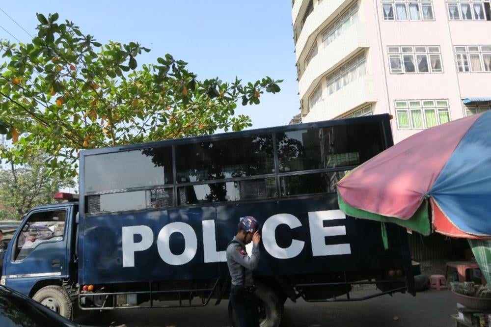 A police van transporting students arrested for protesting against military involvement in the government arrives at a courthouse in Rangoon on January 12, 2016. 
