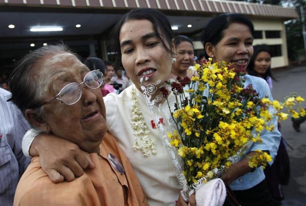 Su Su Nway (center), a labor activist, arrives at Rangoon's domestic airport on October 16, 2011, after being released early from a 12-year prison sentence for sticking anti-government leaflets on a billboard in 2007. 