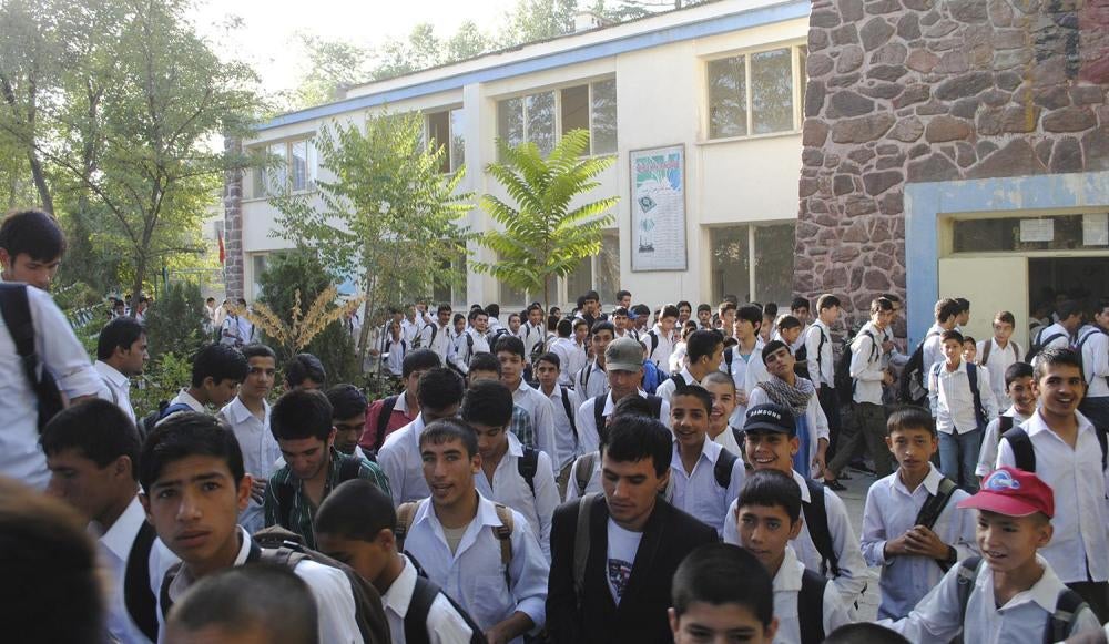 Students at Kabul’s Muhammad Alam Faizzad High School walk toward their classrooms. Many students at this and other schools across Afghanistan are forced to combine the heavy burden of work and school, which often compels students to quit school.  