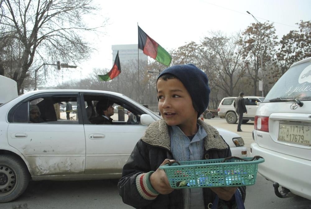 A young boy sells small items on the streets of Kabul. Thousands of children work on the streets of the Afghan capital selling cigarettes, chewing gum, and other merchandise, or working as shoe shines. 